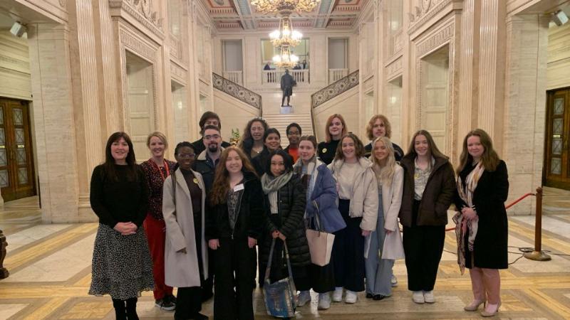 students at a previous public sector tour event standing in a group in a government building
